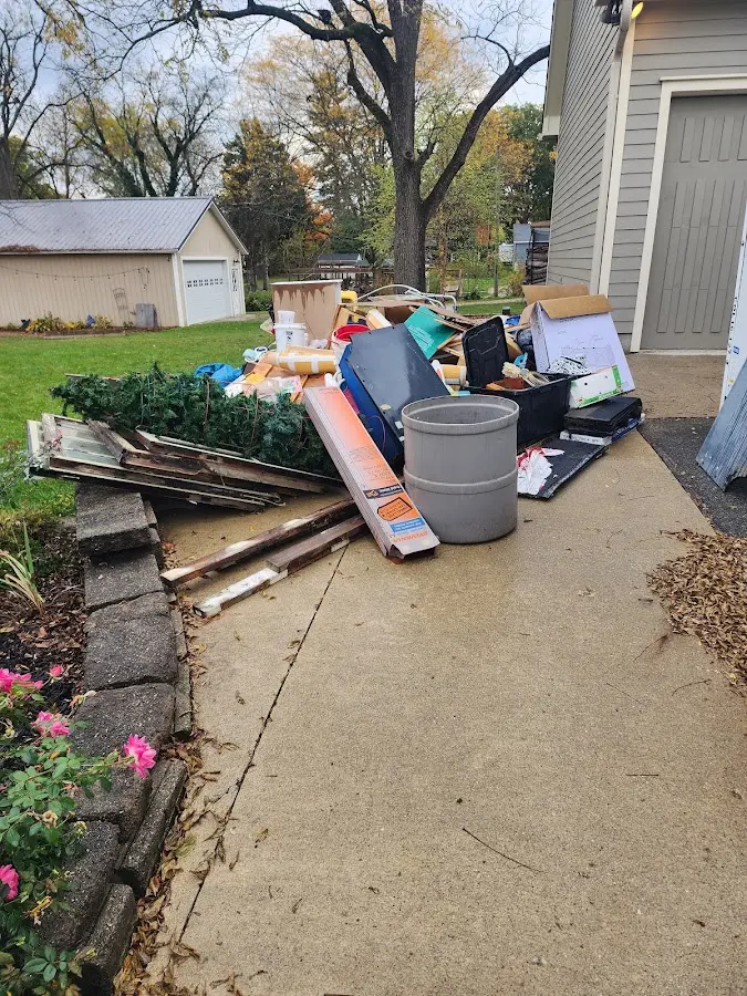 Dumpster being loaded with debris for 12 Yard Dumpster Rental in Glen Carbon